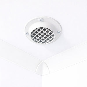 A white circular ceiling vent with a diamond-patterned grille, mounted on a white ceiling corner.