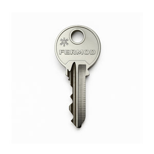 Metal key with 'FERMOD' branding on a white background