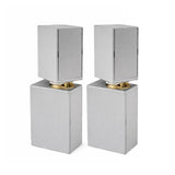 Two silver square-shaped objects with gold bases on a white background