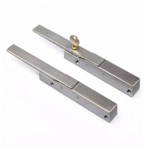 Pair of metallic door handles on a white background