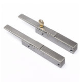 Pair of metallic door handles on a white background
