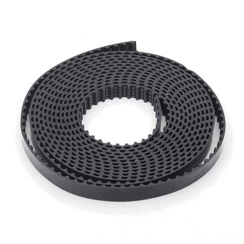 Coiled balck toothed drive belt on white background